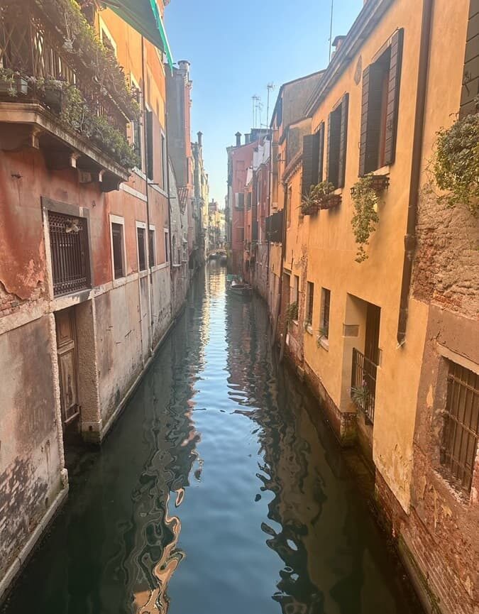 A quiet canal in Venice with historic buildings